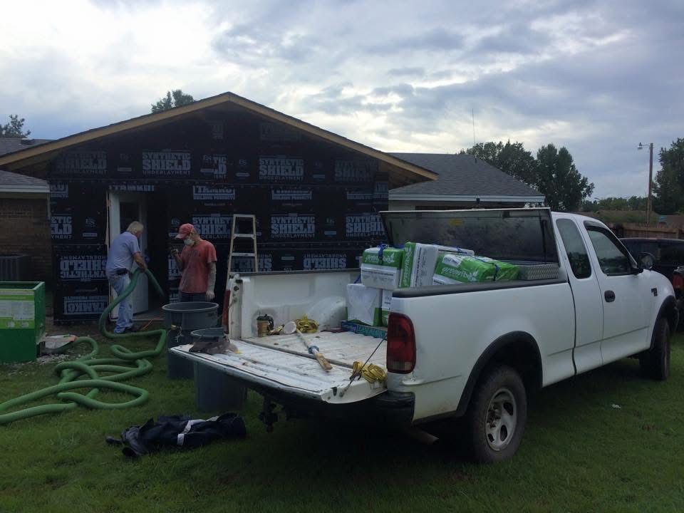 Patriot crew blowing in insulation at a home addition