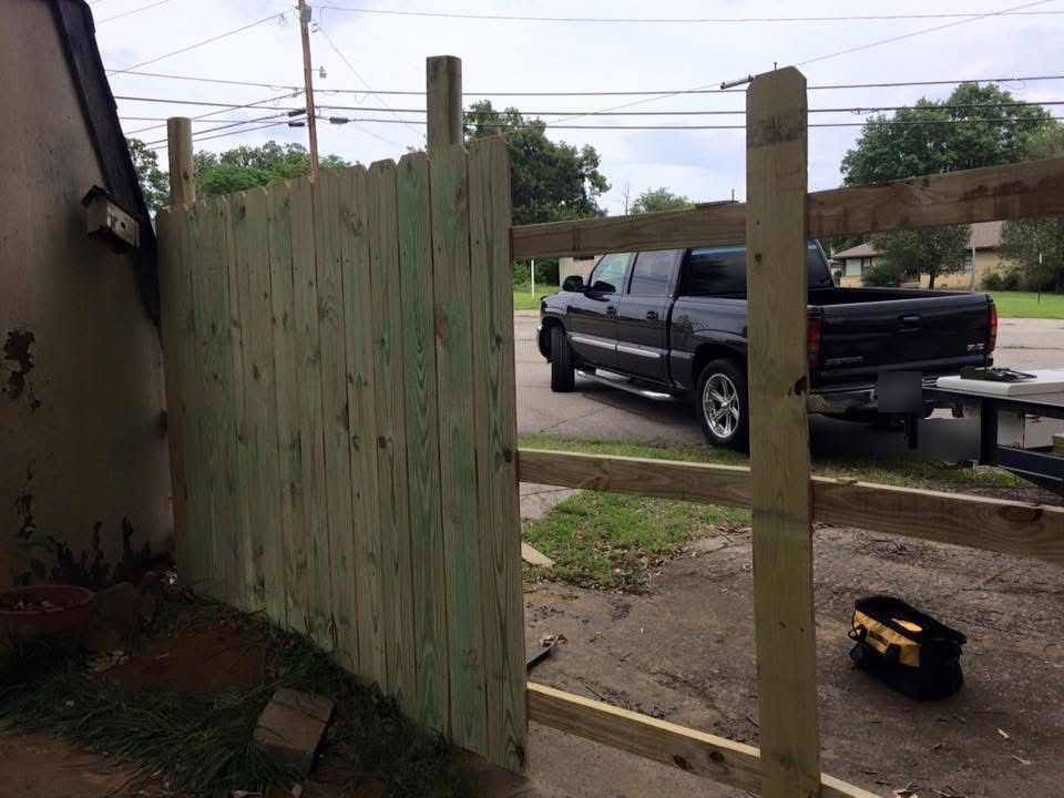 Wood privacy fence under construction