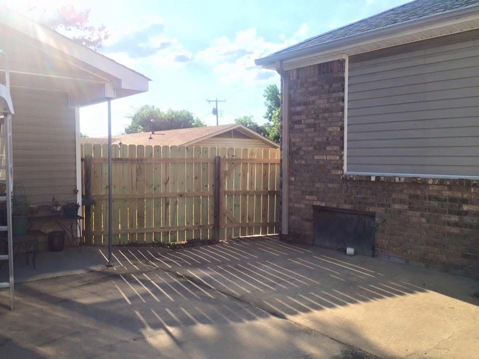 New wood fence with a double drive gate
