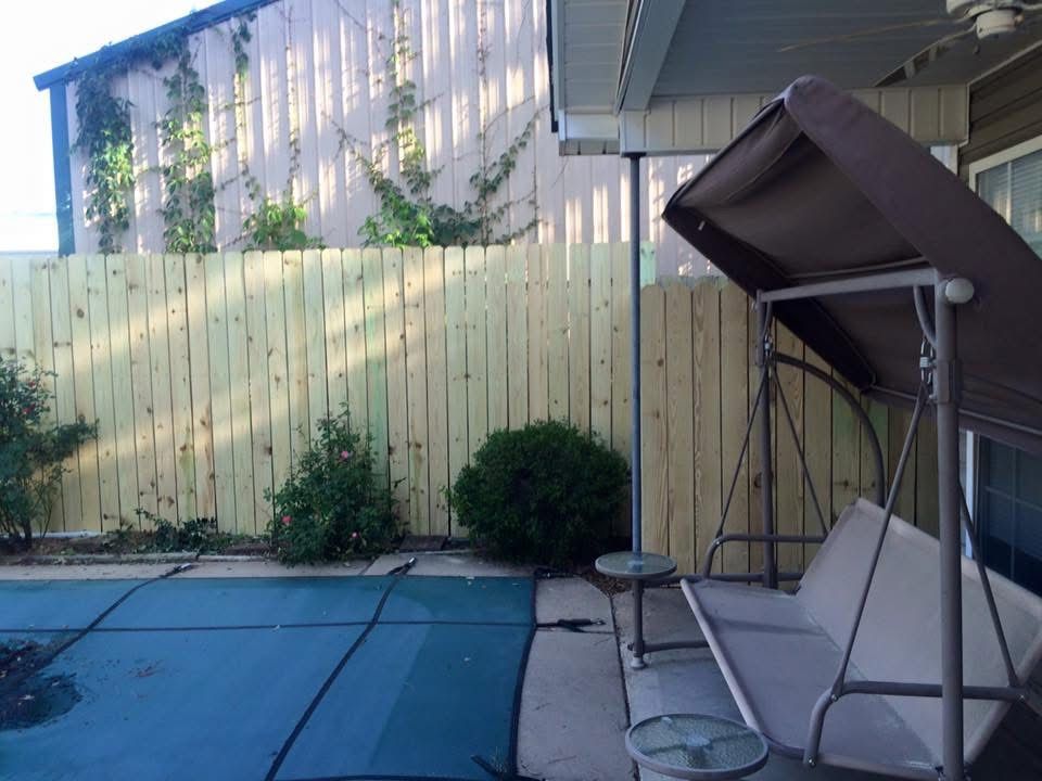 New privacy fence around a pool and patio