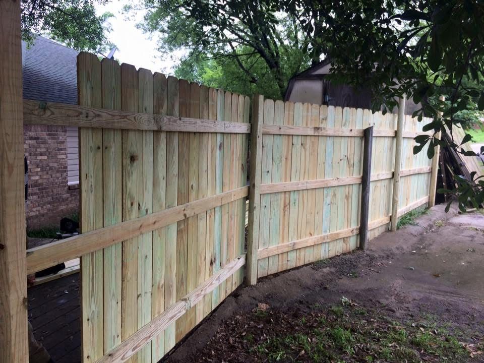 New wood privacy fence along a property line