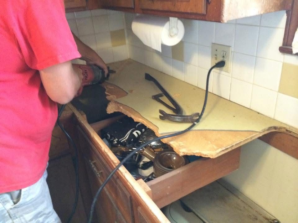 Old kitchen countertop being cut out during demolition