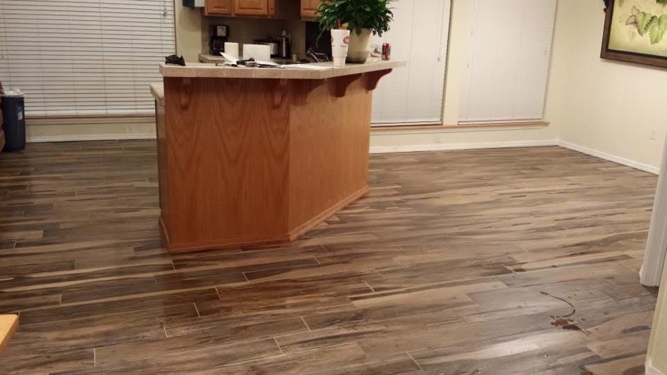Wood-look tile floor around a kitchen island